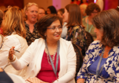 Two women coaching one another at One Woman Conference.