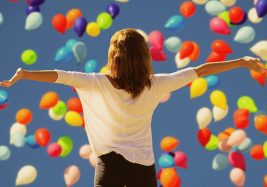 Woman with arms outstretched: How to be confident